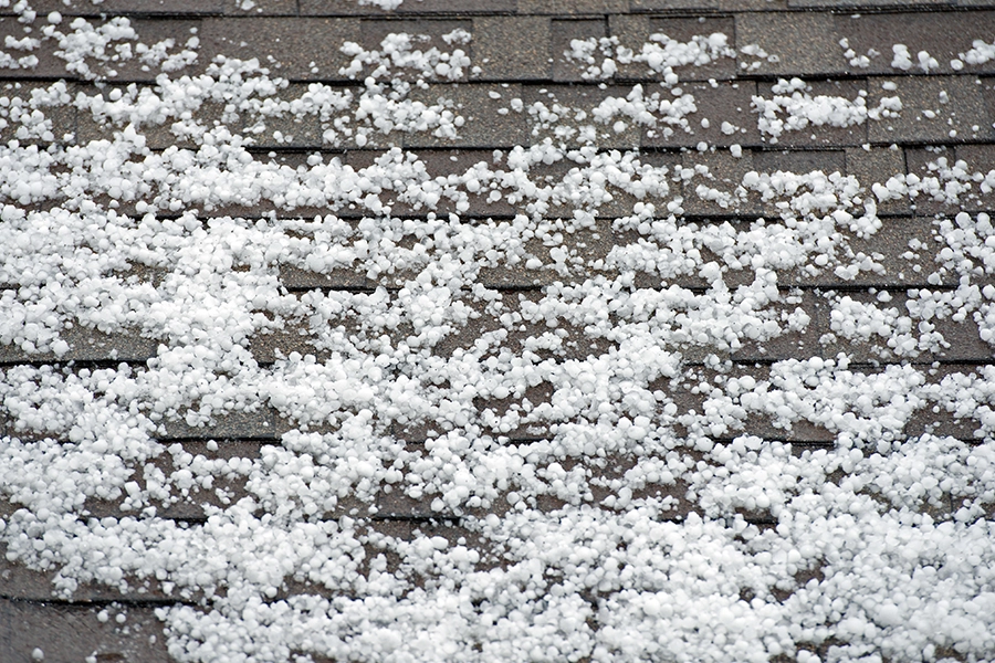 a plethora of fresh hail resting on top of a residential roof in Central IL